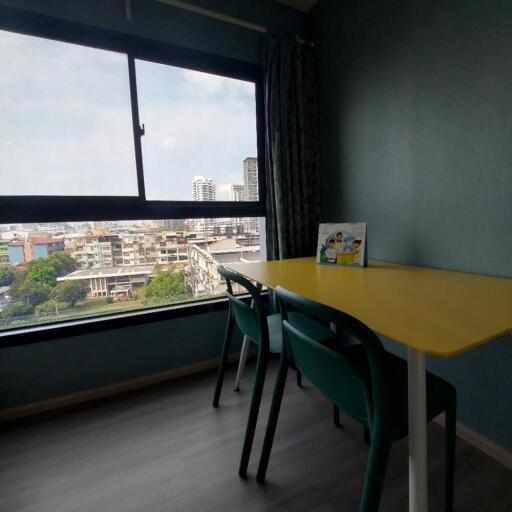 room with window view and yellow table