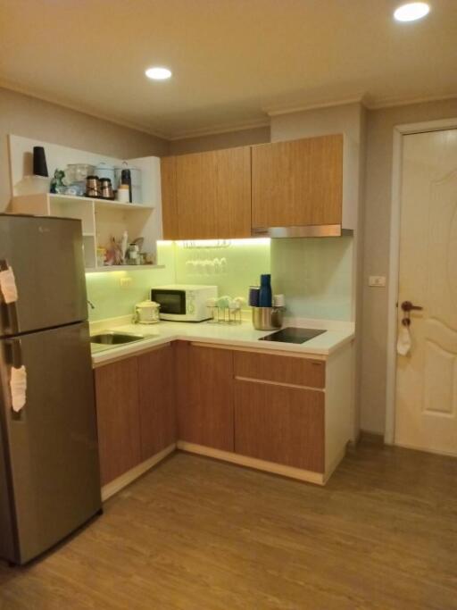 Modern kitchen with wooden cabinets and integrated appliances