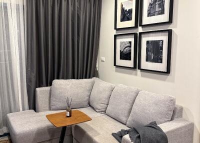 Modern living room with gray sofa and wall art