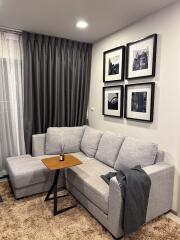 Modern living room with gray sofa and wall art