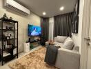 Modern living room with sectional sofa and wall-mounted TV