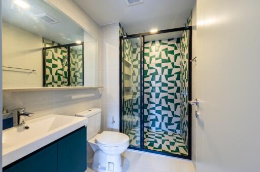 Modern bathroom with geometric shower tiles