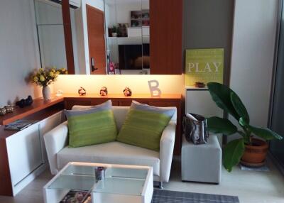 Modern living room with white furniture and green pillows