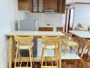 Open kitchen area with wooden cabinets and bar stools