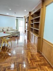 Living room with wooden flooring and built-in shelves