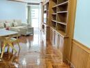 Living room with wooden flooring and built-in shelves