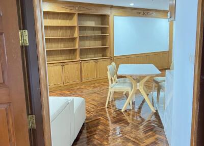 Living room with wooden furniture and built-in shelves