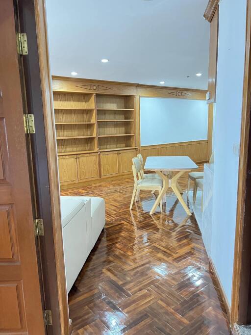 Living room with wooden furniture and built-in shelves