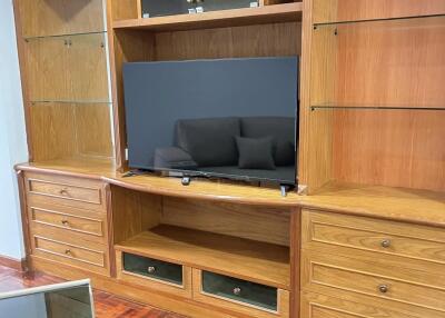 Living room with wooden entertainment center and flatscreen TV