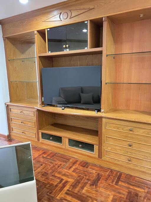 Living room with wooden entertainment center and flatscreen TV