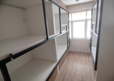 Compact bedroom with multiple bunks and large window