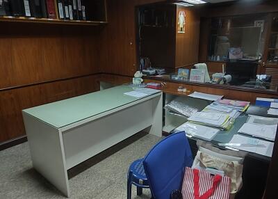 An office with a desk, chair, and documents