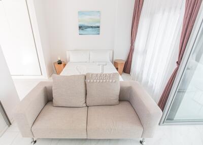 Modern bedroom with a sofa and a large window