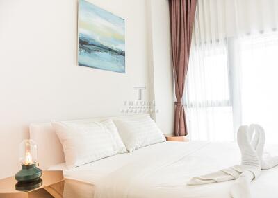 Modern bedroom with artwork and natural light