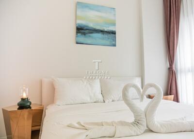 Bedroom with decorative towel swans and minimalistic decor