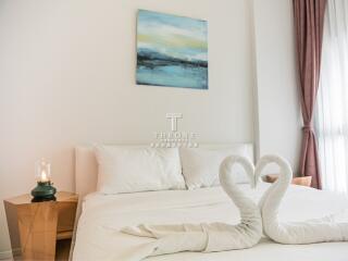 Bedroom with decorative towel swans and minimalistic decor