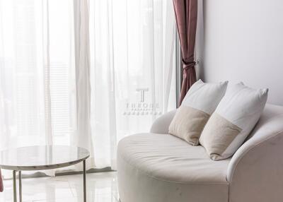 Modern living room with white sofa and glass coffee table