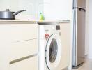 Modern kitchen with a washing machine and refrigerator