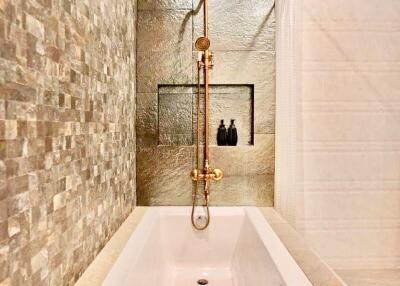 Modern bathroom with a bathtub and stylish shower fixtures
