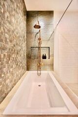 Modern bathroom with a bathtub and stylish shower fixtures