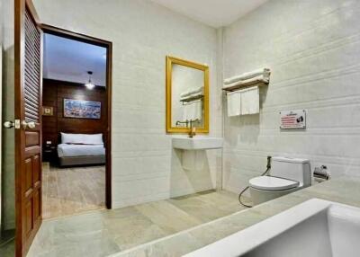Modern bathroom with white fixtures and large wall mirror