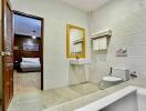 Modern bathroom with white fixtures and large wall mirror