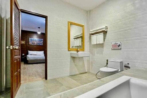 Modern bathroom with white fixtures and large wall mirror