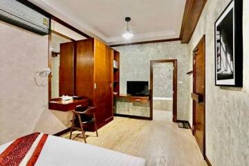 Bedroom with wooden furniture and TV