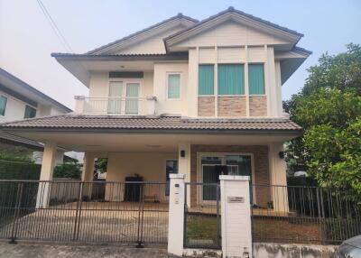 Two-story house with a fenced yard and balcony