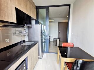 Modern kitchen with dining area and balcony