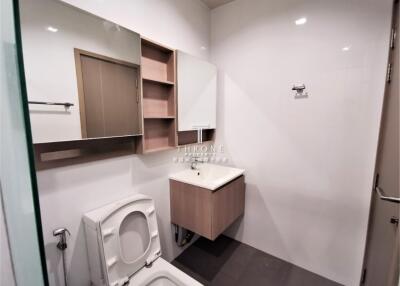 Modern bathroom with sink, mirror cabinet, and toilet