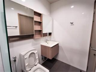 Modern bathroom with sink, mirror cabinet, and toilet