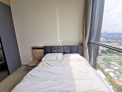 Modern bedroom with large window and city view