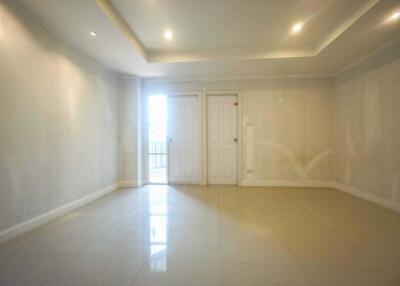 Spacious empty living room with tile flooring and recessed lighting