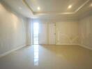 Spacious empty living room with tile flooring and recessed lighting