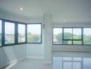 Spacious living room with large windows and natural light