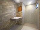 Modern bathroom with tiled walls and floating sink