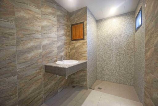 Modern bathroom with tiled walls and floating sink