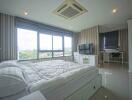 Modern bedroom with large window, double bed, and TV