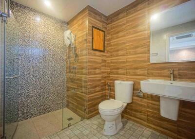 Modern bathroom with wood effect tiles and walk-in shower