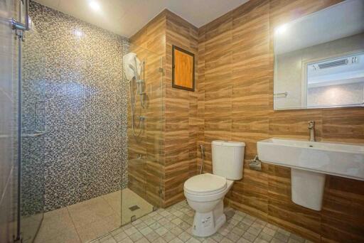 Modern bathroom with wood effect tiles and walk-in shower