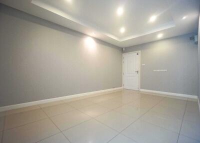 Spacious living room with tiled flooring and recessed lighting