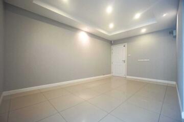 Spacious living room with tiled flooring and recessed lighting