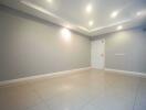 Spacious living room with tiled flooring and recessed lighting