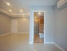 Spacious living area with view into a bathroom