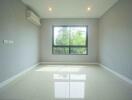 Empty bedroom with large window, air conditioning unit, and tiled floor