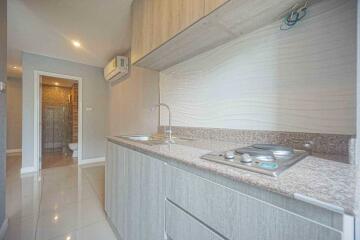 Modern kitchen with wooden cabinetry and granite countertop