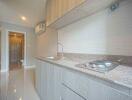 Modern kitchen with wooden cabinetry and granite countertop