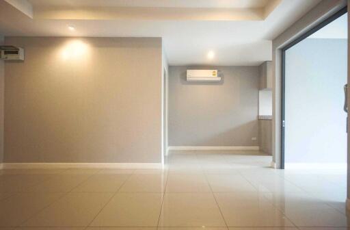 Open living and kitchen area with tiled floor and air conditioning