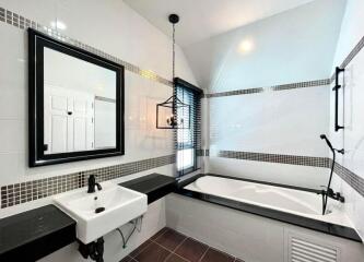 Modern bathroom with white tiles and black accents